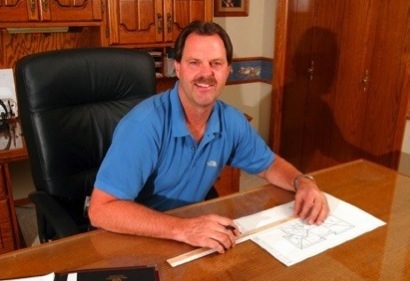 Steve Stucky Sitting at a Desk With Building Plans